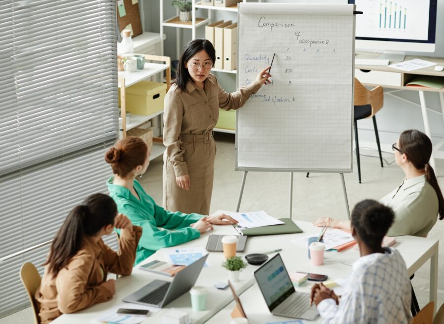 Businesswoman presenting report at business training Businesswoman presenting report at business training