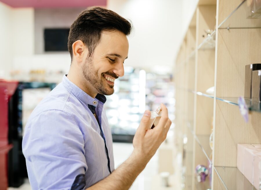 Handsome man buying fragrances