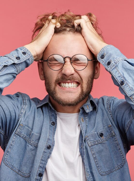 Mad crazy man regrets awful mistake, clenches teeth with annoyance, understands that he can`t change