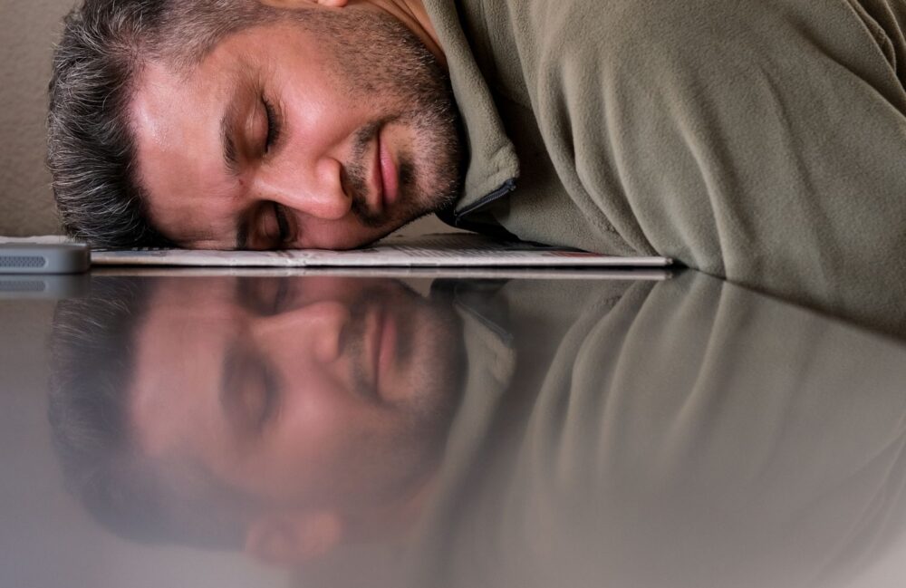 Exhausted person at desk