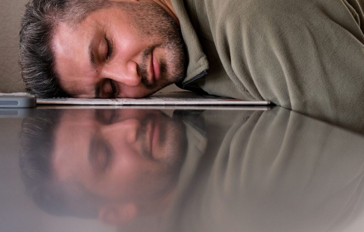 Exhausted person at desk