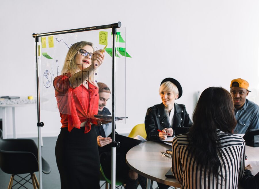Portrait of young female team leader of talented freelances organizing work of members motivates and