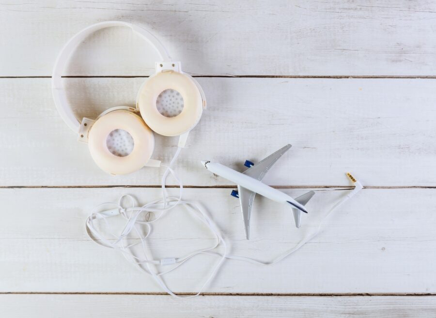 preparation for traveling concept on a model plane airplane on light background